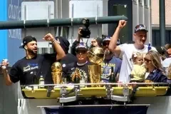 NBA star player for the Denver Nuggets Jamal Murray rides alongside other participants in the 2023 Denver Nuggets Championship Parade. (Public Domain)