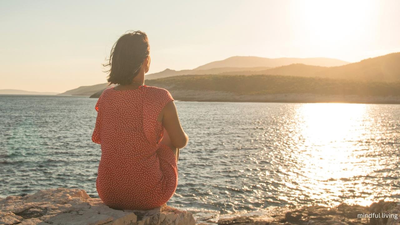 reflecting woman looking over water.png